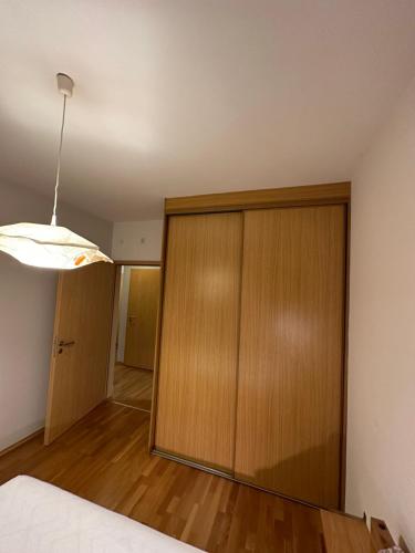 a bedroom with a large wooden cabinet and a light at Central apartment with balcony in Budapest
