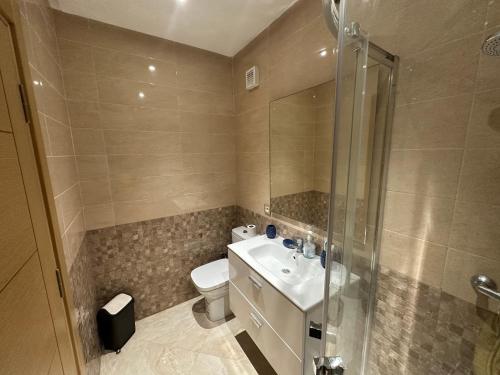 a bathroom with a toilet and a sink and a shower at Casa bay sidi rahal in Sidi Rahal