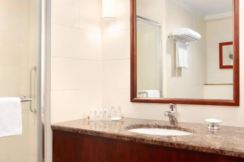 een badkamer met een wastafel en een spiegel bij Le Meridien Towers Makkah in Mekka