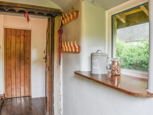 a room with a window and a shelf with a pot on it at Ty Dyfnant Cottage in Penmachno