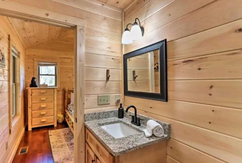 a bathroom with a sink and a mirror at New Serene, Fun & Comfy Cabin- Covered Deck, Grill, Arcade in Murphy