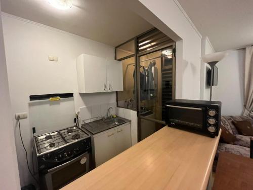 a small kitchen with a stove and a refrigerator at Apartamento Amoblado 348 Ovalle in Ovalle