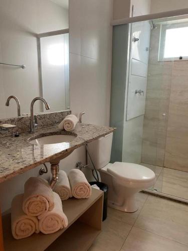 a bathroom with a sink and a toilet and a shower at Salinas Park Resort in Salinópolis