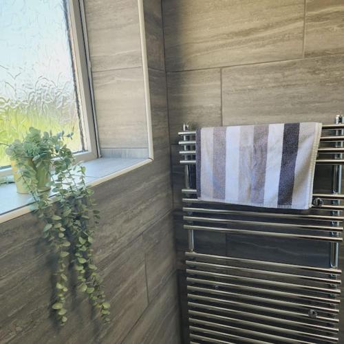 a towel rack in a bathroom with a window at Sunny South Shields House in Jarrow
