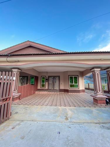 a house with a driveway in front of it at Ceiba View Homestay in Dungun