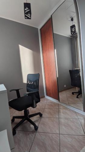 a office with a chair and a mirror at Seaside Apartment in Gdańsk