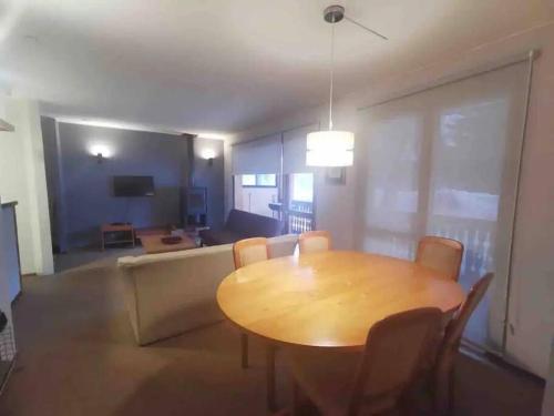 a dining room with a table and a couch at Departamento Termas de Chillán in Pinto