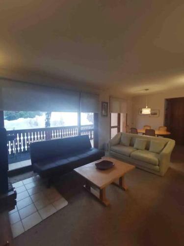 a living room with a couch and a coffee table at Departamento Termas de Chillán in Pinto