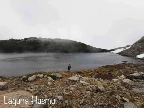 a person standing next to a body of water at Departamento Termas de Chillán in Pinto