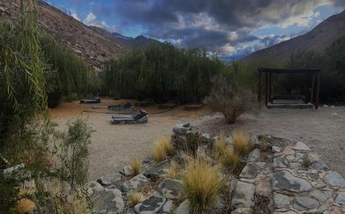 a view of a desert area with trees and a shelter at Alcohuaz Indomito in Alcoguaz