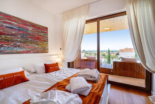 a bedroom with a large bed and a large window at Villa Nena in Kakma