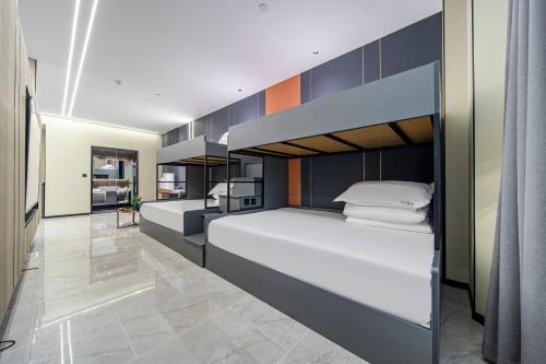 a bedroom with two bunk beds and a hallway at Fd Club Hotel - Qian Tan in Shanghai