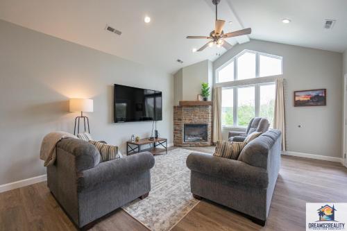 a living room with two chairs and a fireplace at Luxury 3BR Condo - Stairs Required - Resort Amenities - FREE TICKETS INCLUDED - FHG-308 in Branson
