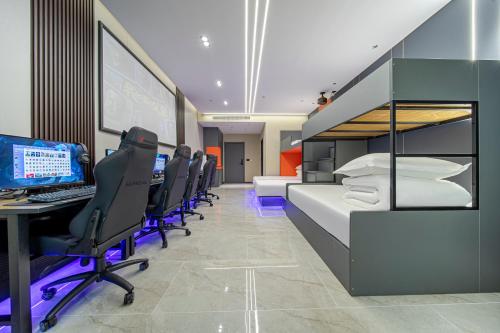 a room with a bed and a desk with a computer at Fd Club Hotel - Qian Tan in Shanghai