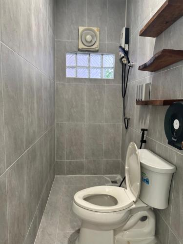a bathroom with a toilet and a phone on the wall at Kala Krang Nueng in Ko Samed