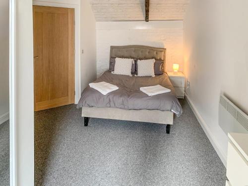 a bedroom with a bed with two towels on it at Sutton Windmill in Hickling