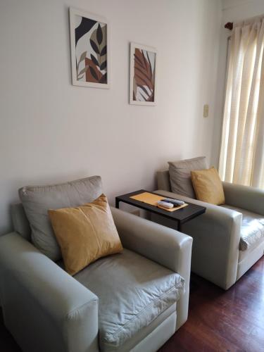a living room with a couch and a table at Bienestar Haedo in Mariano J. Haedo