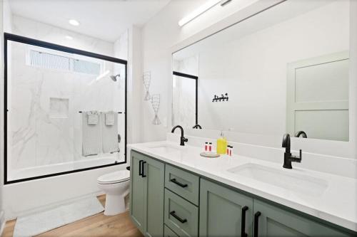 a bathroom with a sink and a toilet and a shower at Tortuga Tillys in Cape San Blas