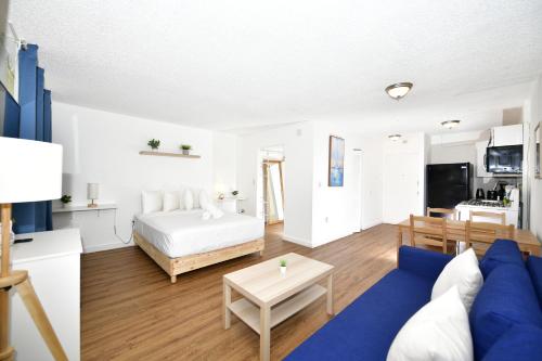 un soggiorno con letto e divano blu di Sobe Apartments a Miami Beach