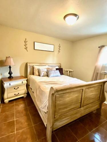 a bedroom with a large bed and a night stand at A Cozy Corner in San Antonio