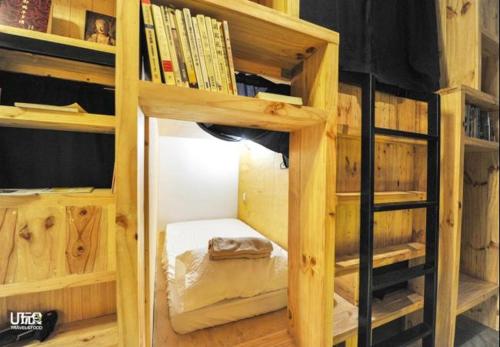 a wooden book shelf with a bed in it at Route Five Hostel Dorm Kuala Selangor in Kuala Selangor
