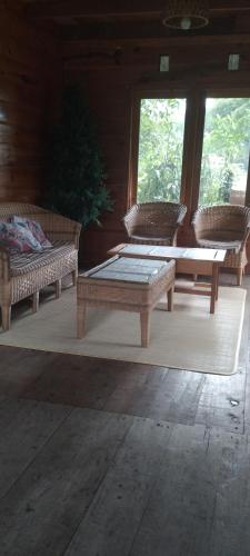 a room with two benches and a table and windows at Purabarang Homestay in Rantepao