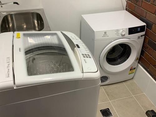 a washing machine sitting next to a washer at Wynyardway in Tumut