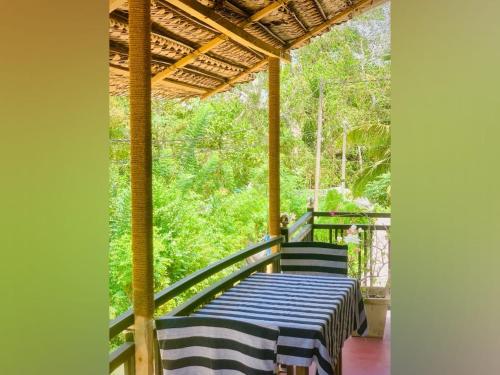 a porch with a blue and white table and chairs at Vinu’s Place in Matara