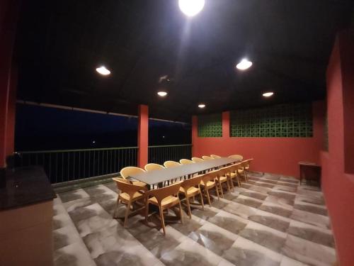 a row of chairs in a room with red walls at Gulzar 2BHK Service Apartment, kannur in Kannur