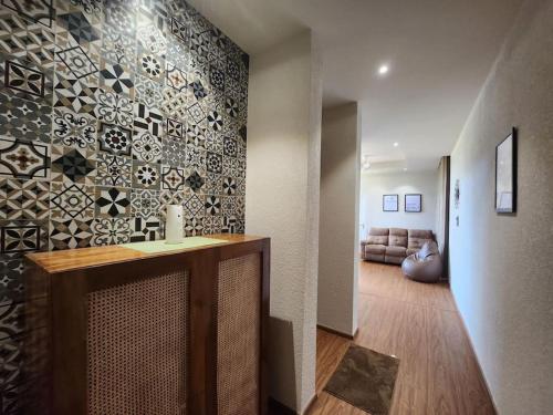 a room with a counter and a living room at Gulzar 2BHK Service Apartment, kannur in Kannur