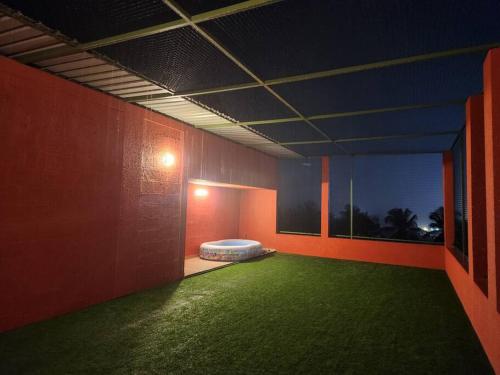 a room with a green floor and a mattress in it at Gulzar 2BHK Service Apartment, kannur in Kannur
