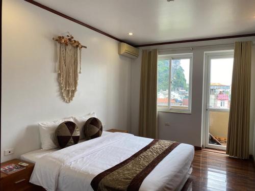 a bedroom with a large bed and a window at citybay homestay ha long 3BR in Ha Long
