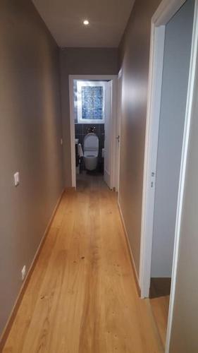 an empty hallway with a toilet in a room at Cosy villa with pool near ocean in Labenne