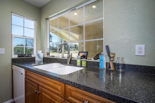 a kitchen counter with a sink and a window at Peaceful Home with Nature Views & Trail Access in Yucca Valley