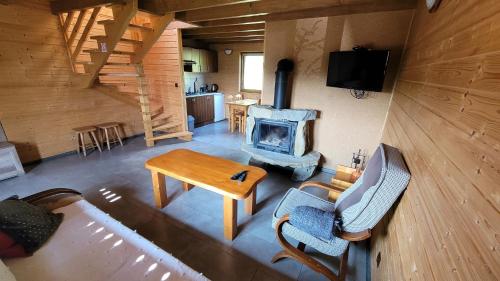 an overhead view of a living room with a fireplace at domki nad jeziorem in Wołkowyja