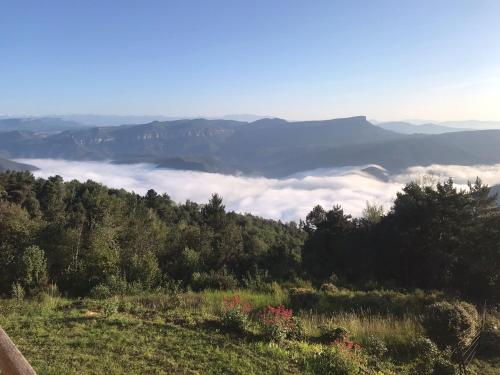a view of a valley of clouds in the mountains at Casa de muntanya Can Coll de Susqueda Girona in Susqueda