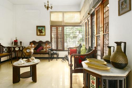 a living room filled with lots of vases on tables at Laika Boutique Stay in Bengaluru
