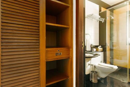 a bathroom with a toilet and a sink at Laika Boutique Stay in Bangalore