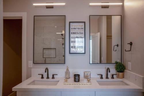 ein Badezimmer mit zwei Waschbecken und einem großen Spiegel in der Unterkunft Clarendon Lux Modern Townhome in Phoenix