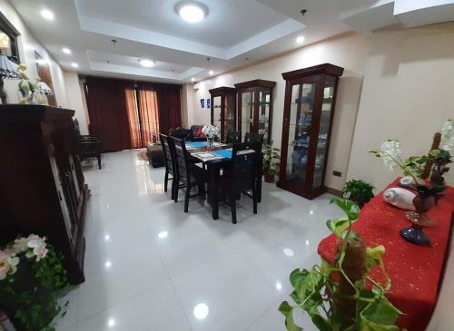 a living room with a dining room table and chairs at HilFrans Lodge in Vigan