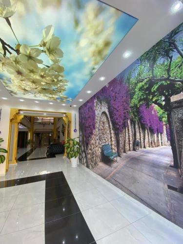 a hallway with a wall with a mural of flowers at En Kaya Hotel in North Nicosia