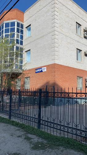 a black fence in front of a building at Kamkor in Atyrau