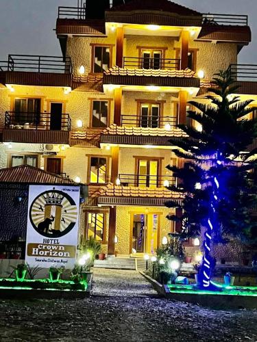 a large building with a sign in front of it at HOTEL CROWN HORIZON in Sauraha