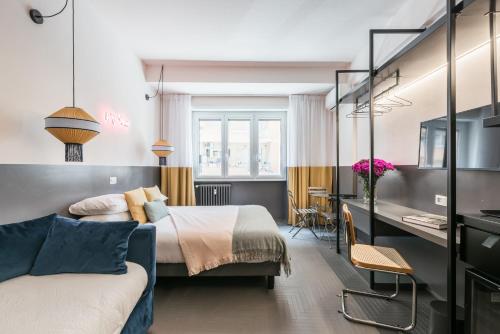 a hotel room with two beds and a desk at MARCANTONIO HOME ROME - Vatican - in Rome