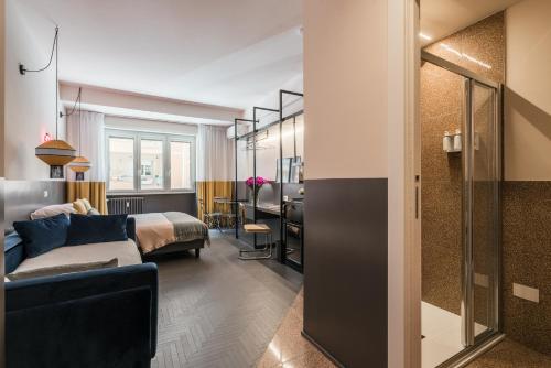 a hotel room with a bed and a living room at MARCANTONIO HOME ROME - Vatican - in Rome
