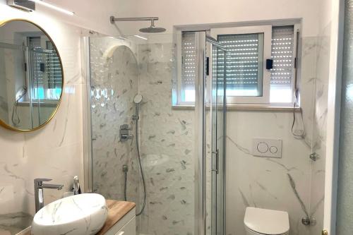 a bathroom with a shower and a toilet and a sink at At Jenny in Omiš