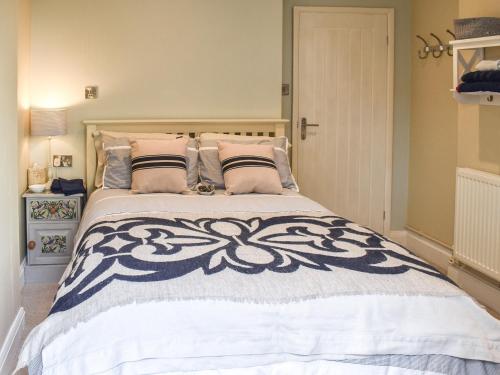 a bedroom with a large bed with pillows at Sams Snug in Birchington