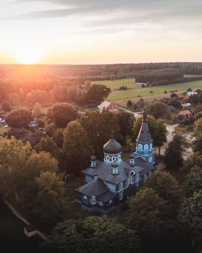 an aerial view of a large house with a tower at Miło las widzieć in Ciwoniuki