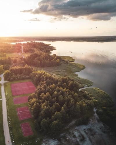 an aerial view of a field in the middle of a lake at Miło las widzieć in Ciwoniuki