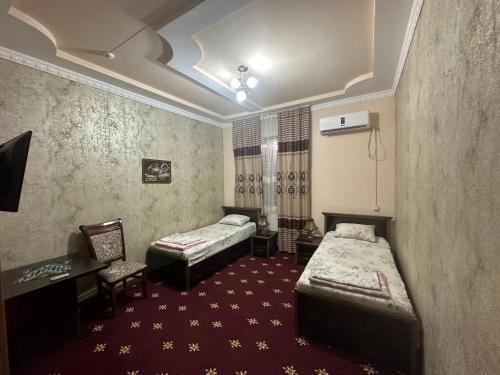Cama ou camas em um quarto em Mumtoz Plaza